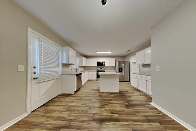 a view of kitchen with wooden floor