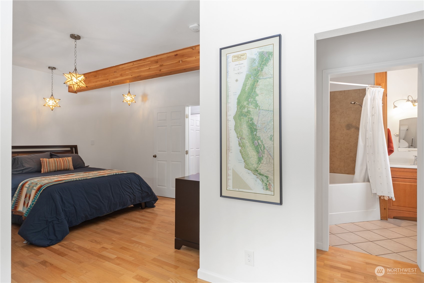 232 Peterson Road Port Townsend, WA 98368 - Photo 8 of 32 a bedroom with a bed and a painting on the wall