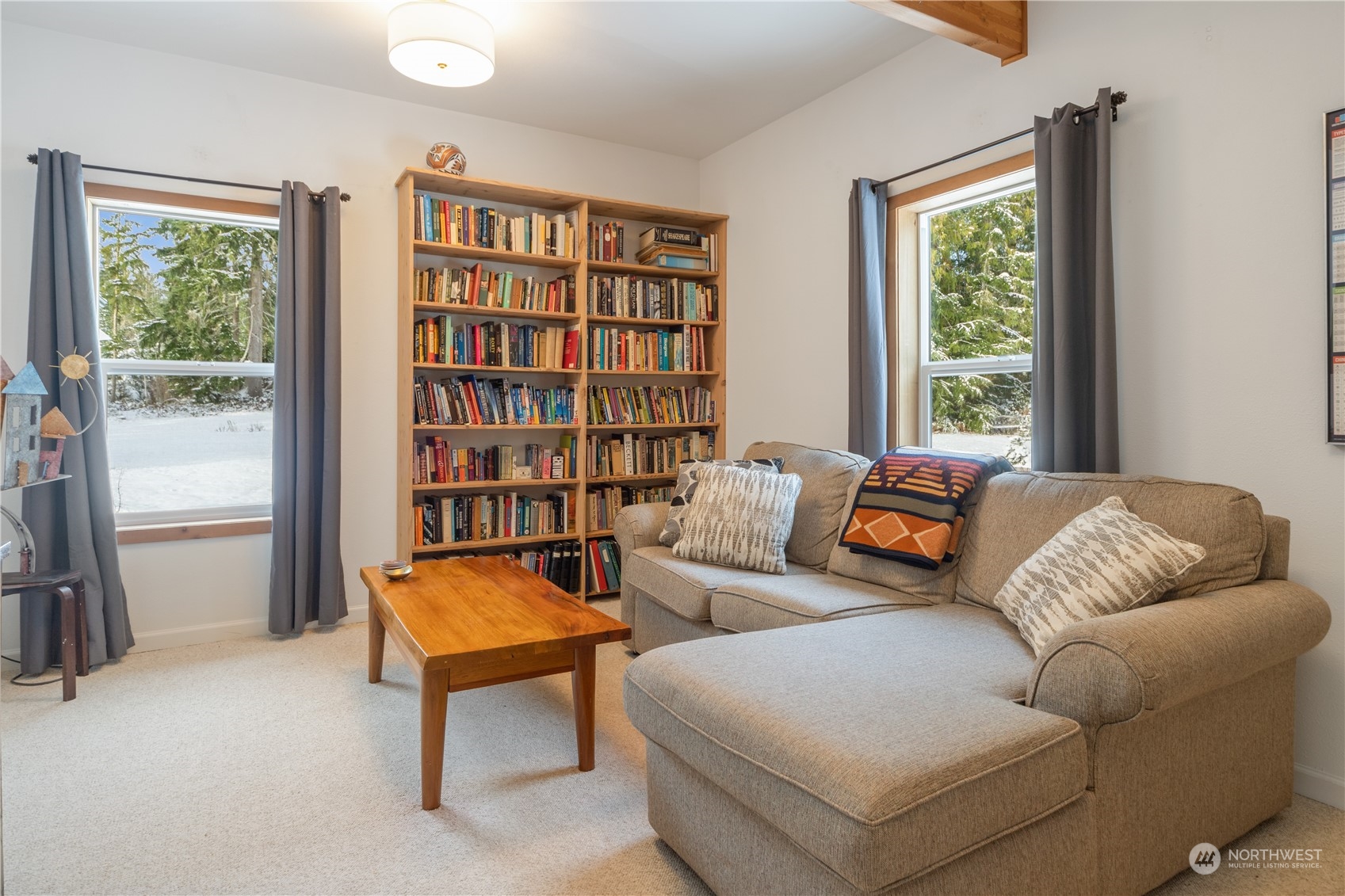 232 Peterson Road Port Townsend, WA 98368 - Photo 10 of 32 a living room with furniture and a book shelf