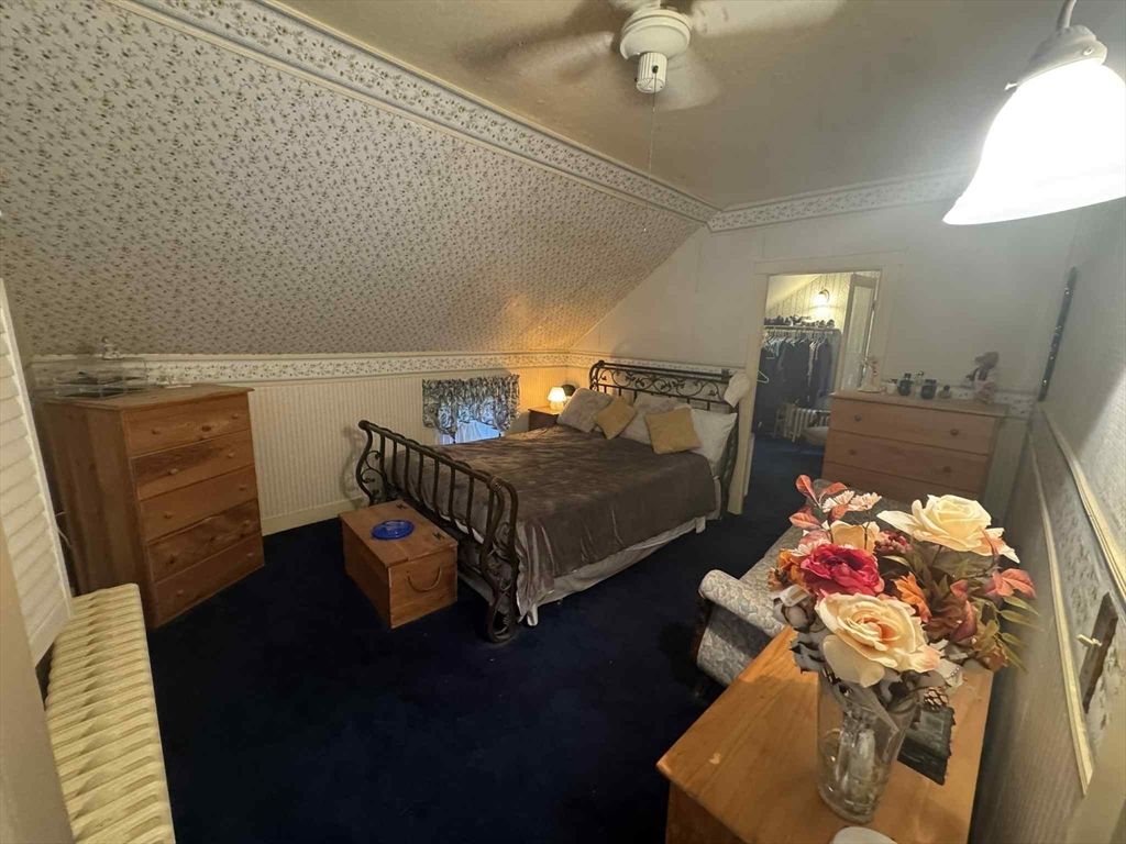 539 Aetna Street Fall River, MA 02721 - Photo 17 of 22 a bedroom with a bed and wooden floor