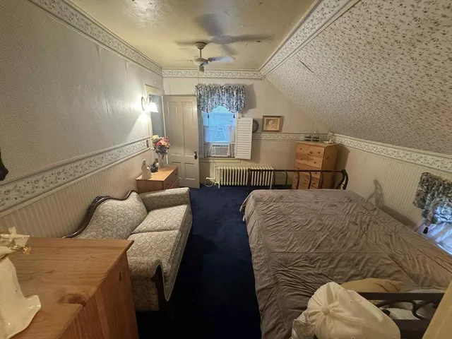 a bedroom with furniture and wooden floor