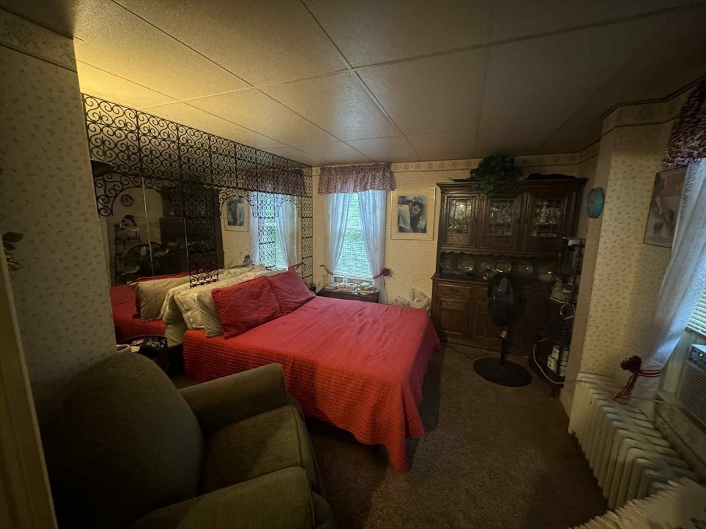 539 Aetna Street Fall River, MA 02721 - Photo 20 of 22 a bed room with a bed and a walk in closet