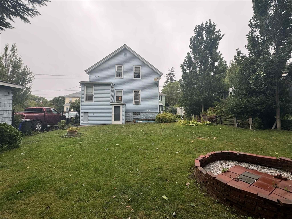 539 Aetna Street Fall River, MA 02721 - Photo 5 of 22 a view of a backyard with couches plants and large trees