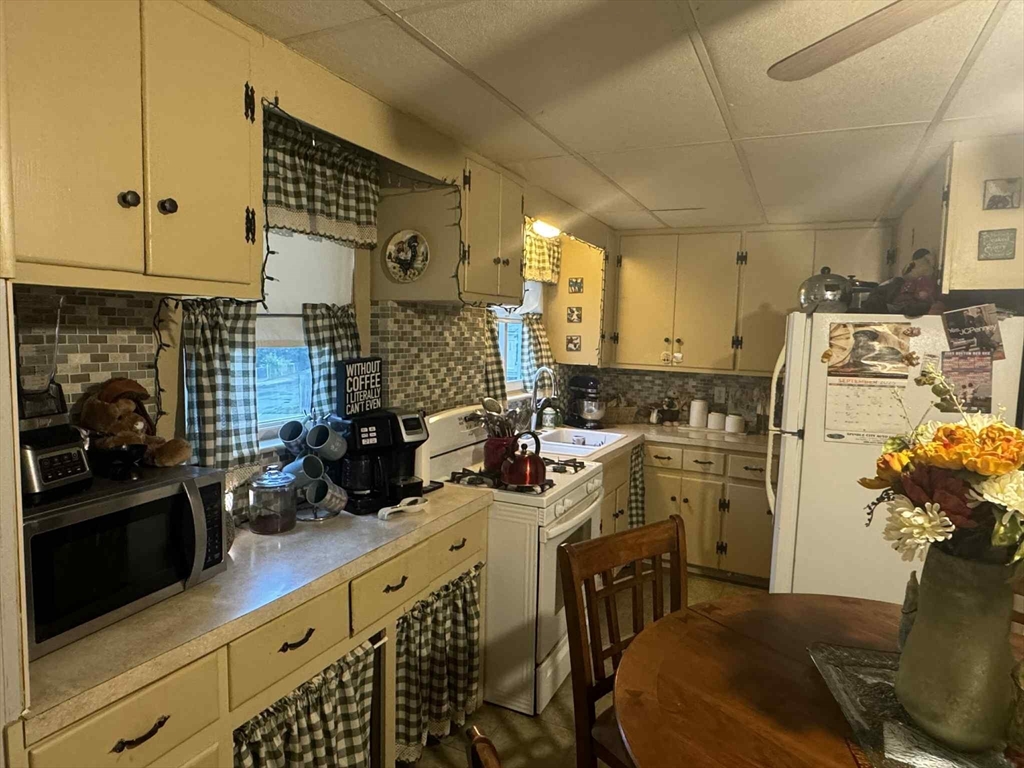 539 Aetna Street Fall River, MA 02721 - Photo 9 of 22 a kitchen with refrigerator and cabinets