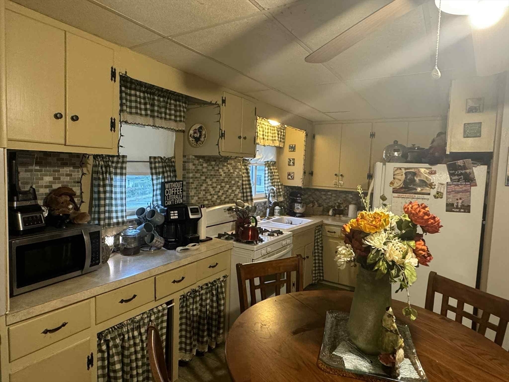 539 Aetna Street Fall River, MA 02721 - Photo 10 of 22 a kitchen with stainless steel appliances a sink a stove cabinets and wooden floor