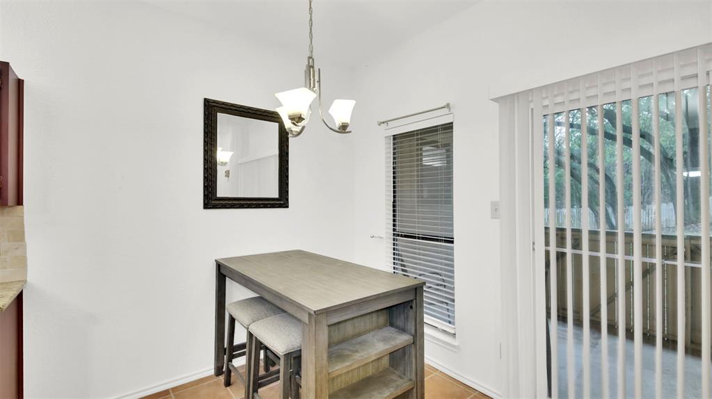 9100 Mountain Ridge Drive, Unit 102 Austin, TX 78759 - Photo 10 of 24 Dining space with a chandelier and light tile patterned flooring