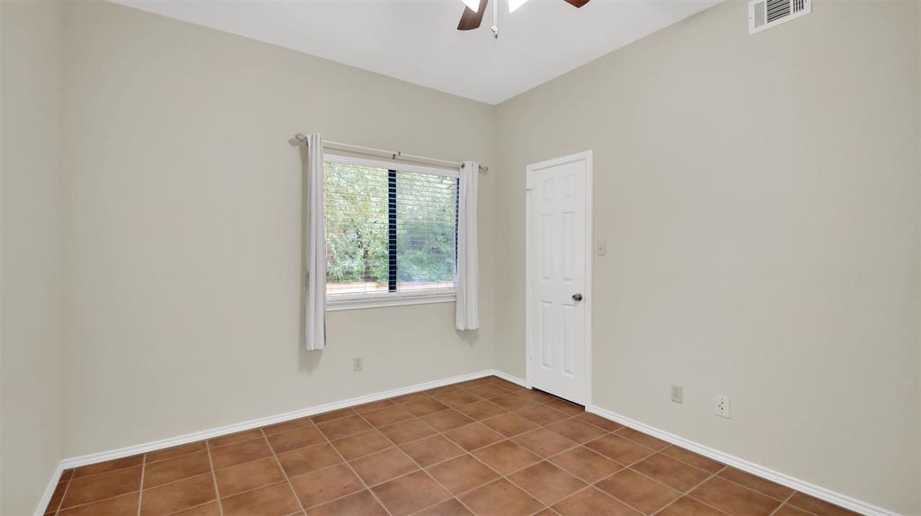 9100 Mountain Ridge Drive, Unit 102 Austin, TX 78759 - Photo 18 of 24 Spare room featuring ceiling fan and baseboards
