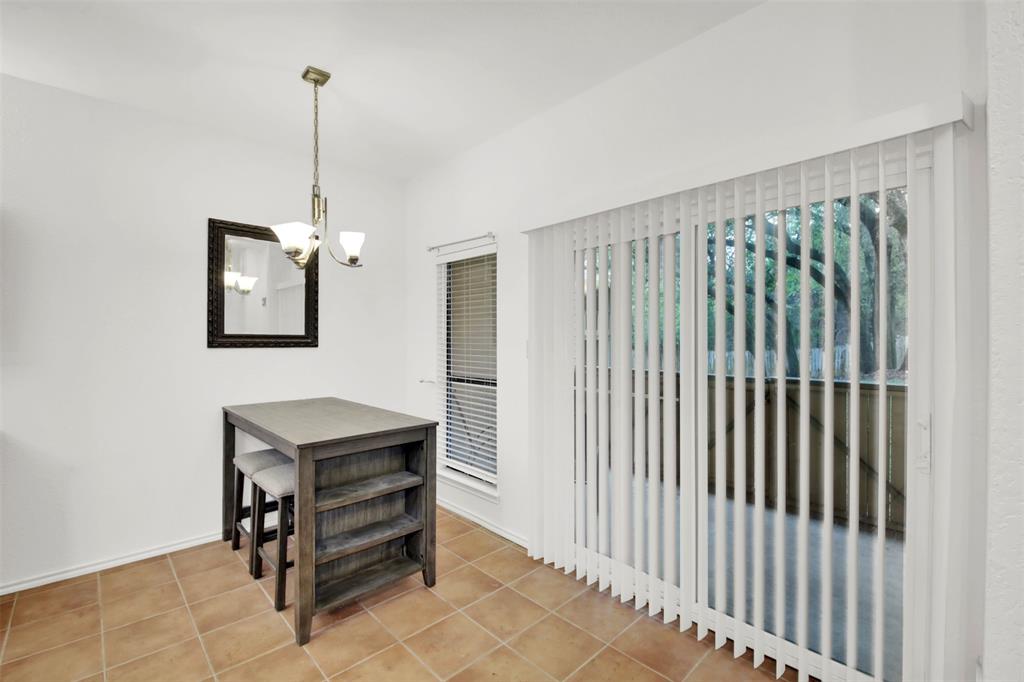 9100 Mountain Ridge Drive, Unit 102 Austin, TX 78759 - Photo 9 of 24 Dining room with a chandelier and light tile patterned flooring