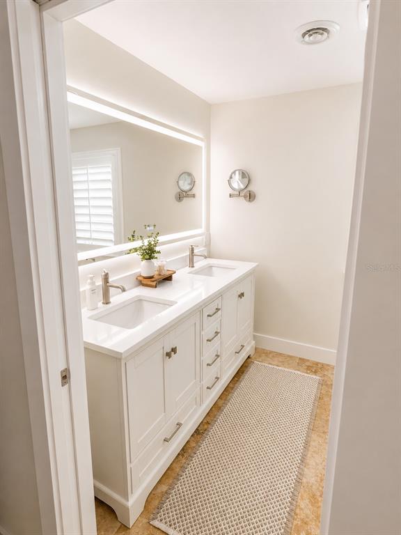 5431 Foley Square New Port Richey, FL 34652 - Photo 23 of 39 a bathroom with a sink a vanity and a mirror