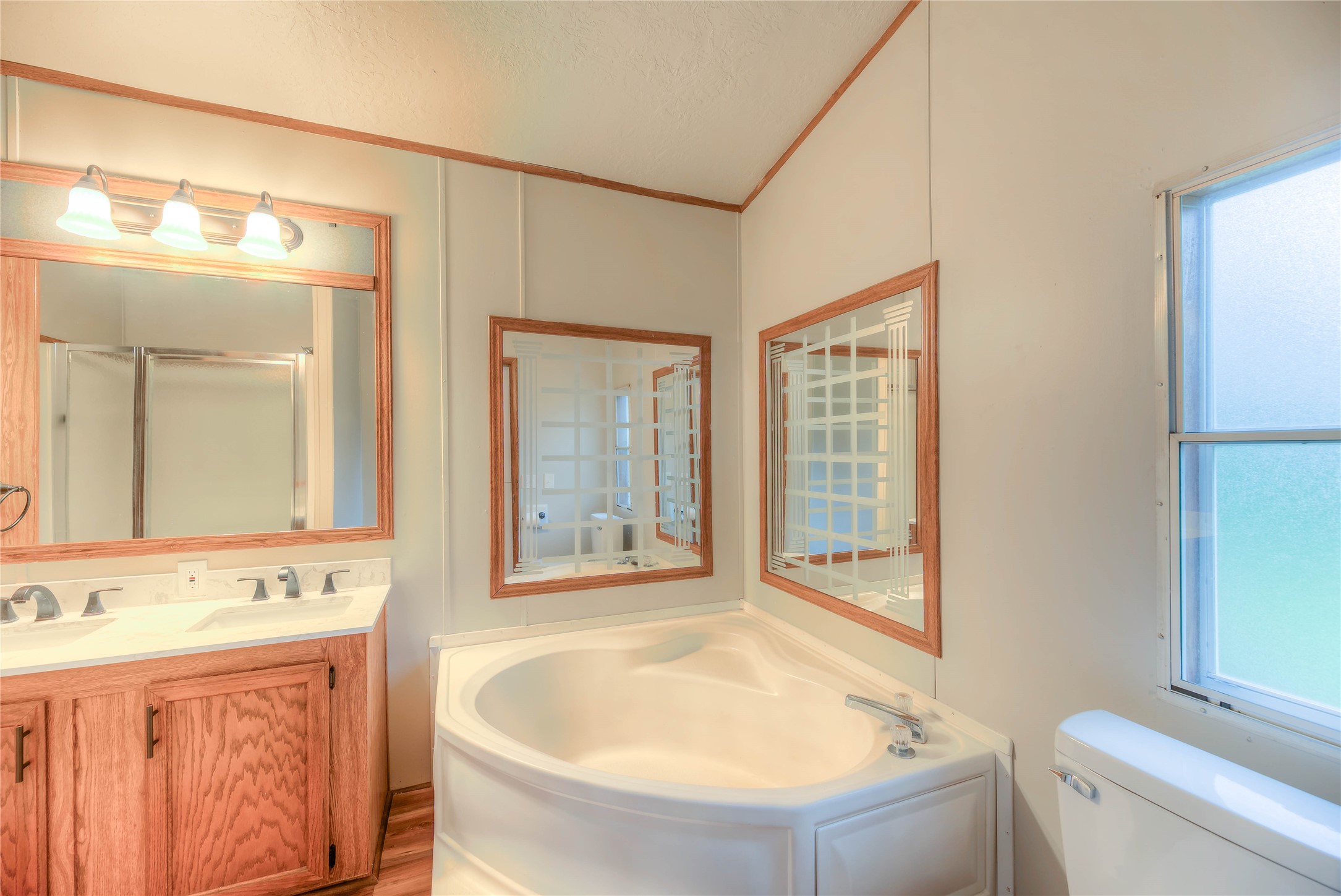 657 Parrish Road Livingston, TX 77351 - Photo 17 of 47 a bathroom with a granite countertop tub sink and mirror
