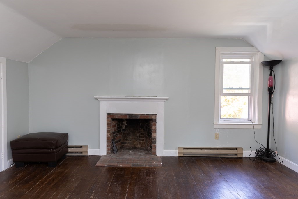 92 Burrington Road Heath, MA 01346 - Photo 25 of 30 an empty room with a fireplace and wooden floor