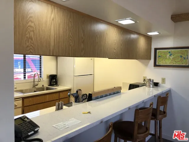 a kitchen with a sink and a refrigerator