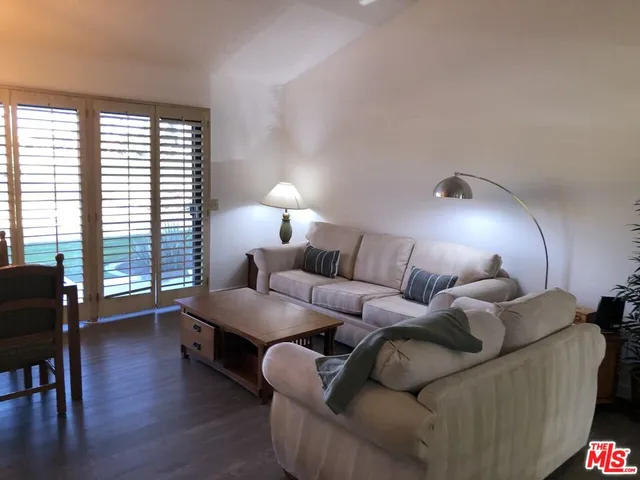 a living room with furniture and a lamp