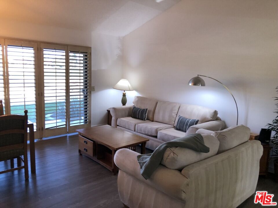 40590 La Costa Circle East, Unit 7303 Palm Desert, CA 92211 - Photo 6 of 14 a living room with furniture and a lamp