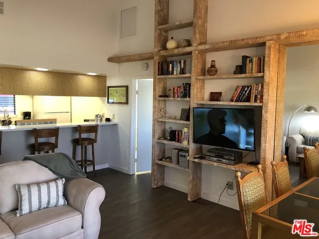 a living room with furniture and a book shelf