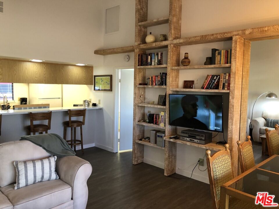 40590 La Costa Circle East, Unit 7303 Palm Desert, CA 92211 - Photo 7 of 14 a living room with furniture and a book shelf