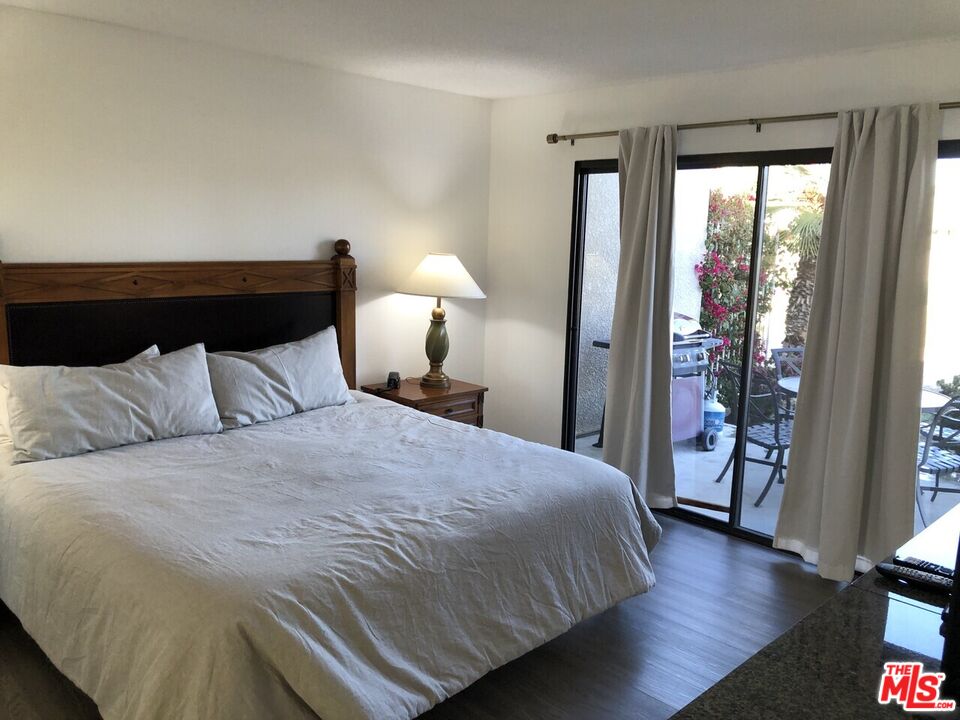 40590 La Costa Circle East, Unit 7303 Palm Desert, CA 92211 - Photo 9 of 14 a bedroom with a large bed and a large window