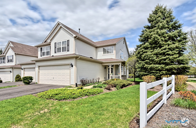 201 Grand Ridge Road St. Charles, IL 60175 - Photo 1 of 20 a front view of a house with a yard and garage