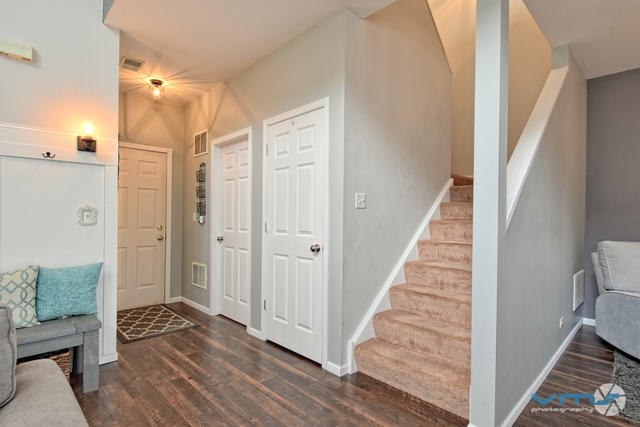 201 Grand Ridge Road St. Charles, IL 60175 - Photo 13 of 20 a view of a hallway with wooden floor and staircase