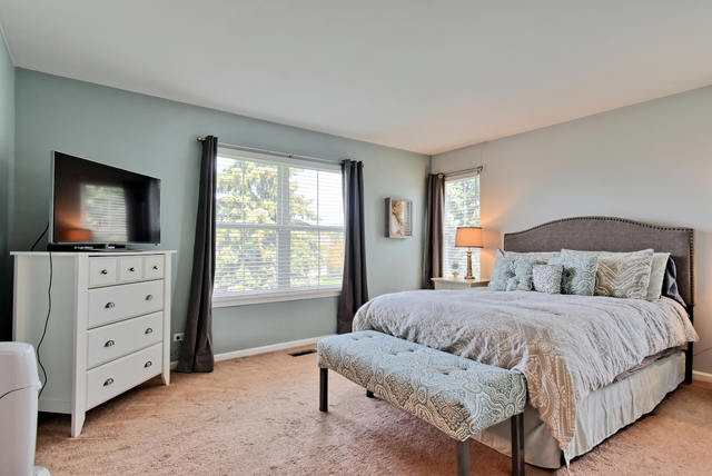 201 Grand Ridge Road St. Charles, IL 60175 - Photo 16 of 20 a bedroom with a bed and flat screen tv