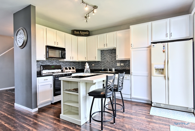 201 Grand Ridge Road St. Charles, IL 60175 - Photo 8 of 20 a kitchen with a refrigerator a stove top oven a sink and cabinets