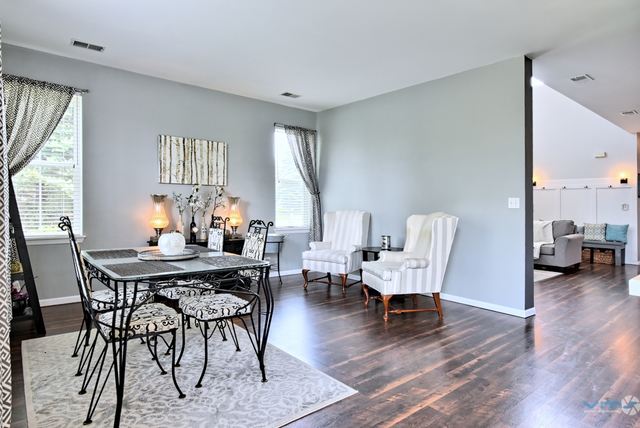 201 Grand Ridge Road St. Charles, IL 60175 - Photo 9 of 20 a view of a dining room with furniture window and wooden floor