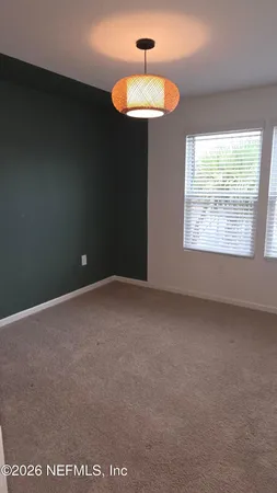 a view of a big room with wooden floor and door