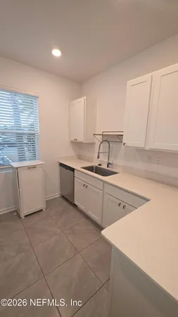 a kitchen with a sink cabinets and window