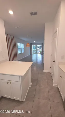 a view of a hallway to rooms and stairs