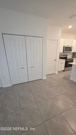 a living room with stainless steel appliances kitchen island granite countertop a sink and cabinets