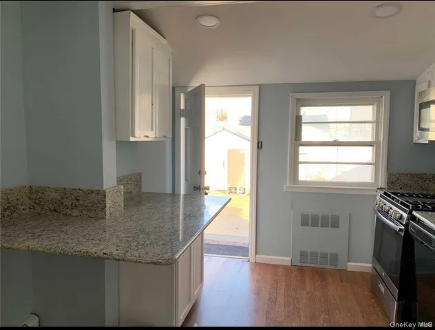 a kitchen with granite countertop a stove and a sink
