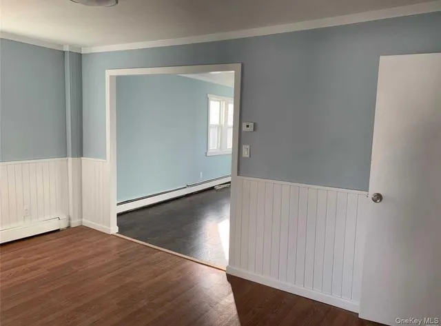 an empty room with wooden floor