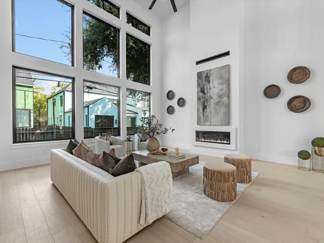 a living room with furniture and large windows