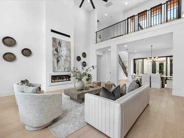 a view of a patio with couches table and chairs and potted plants