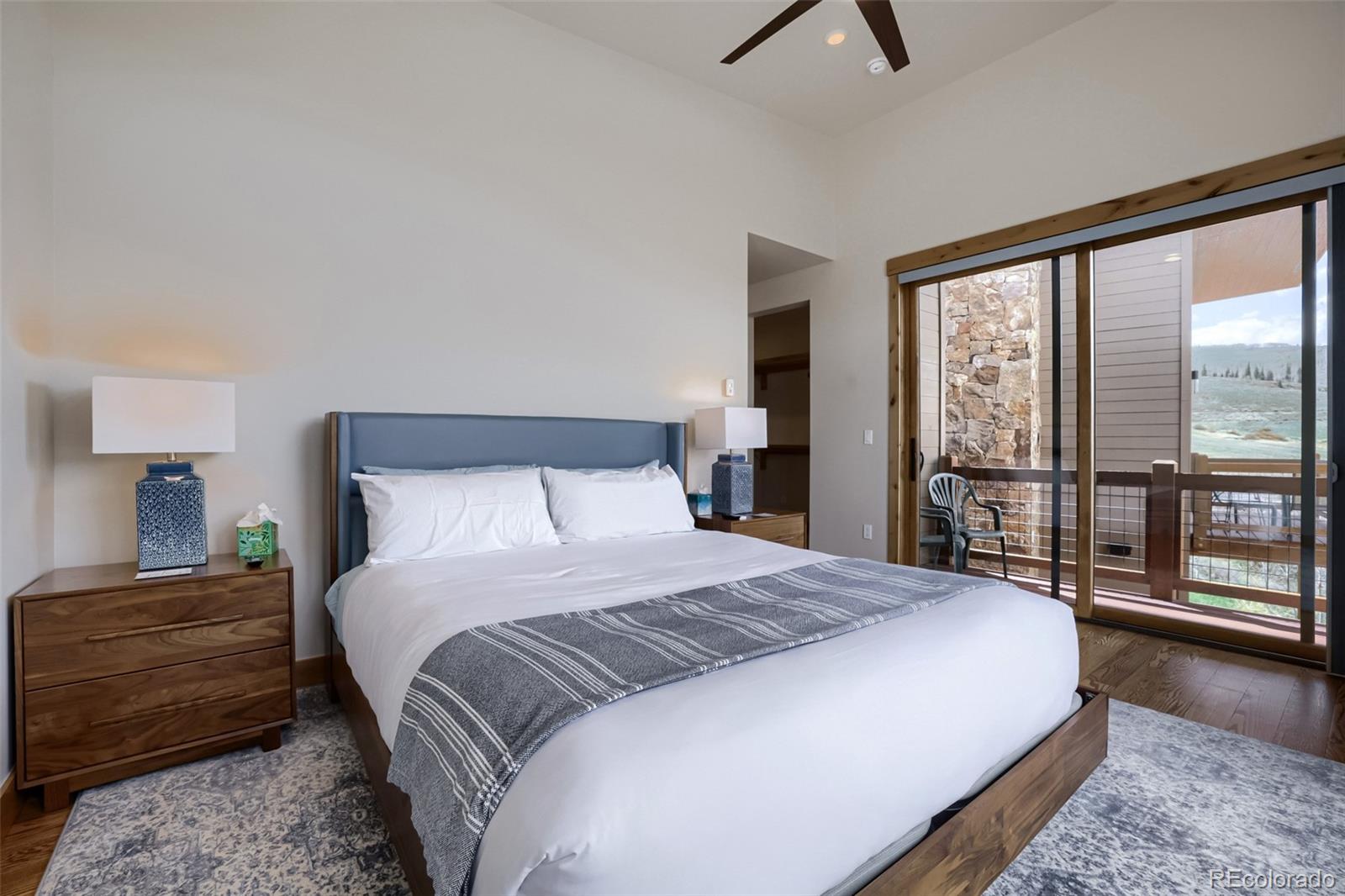 836 Maryland Creek Road Silverthorne, CO 80498 - Photo 11 of 49 a bedroom with a large bed and a large window
