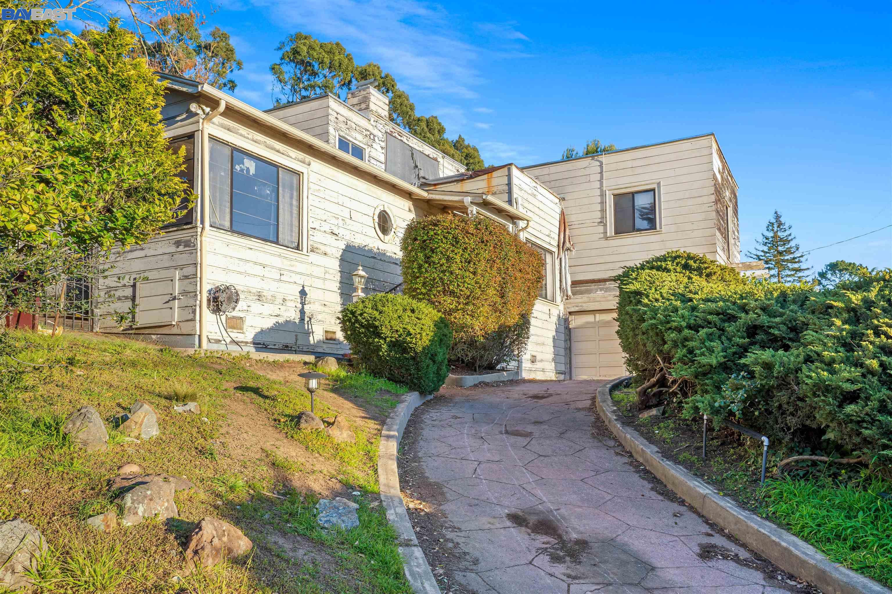 3100 Holyrood Drive Oakland, CA 94611 - Photo 1 of 1 a front view of a house with garden