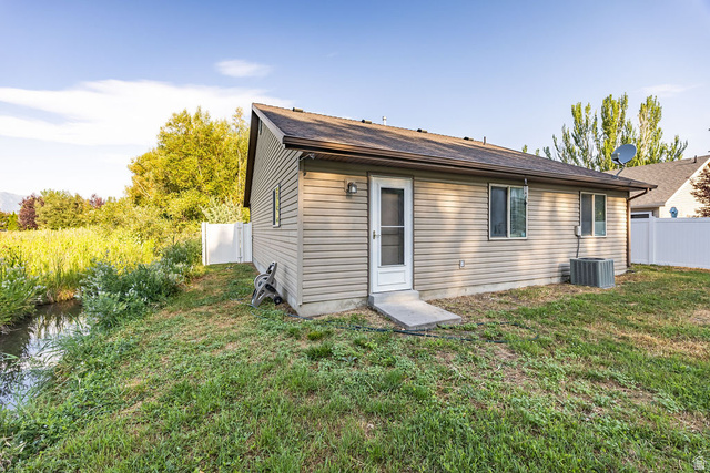 778 South 650 West Logan, UT 84321 - Photo 22 of 26 Exterior siding with multiple windows and a rear entry door