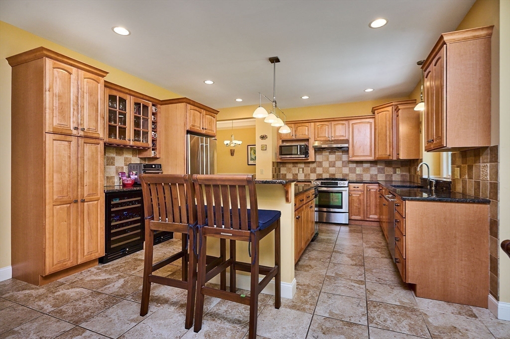 5 Deer Haven Drive Williamsburg, MA 01039 - Photo 16 of 42 a kitchen with stainless steel appliances kitchen island granite countertop a table chairs sink and cabinets