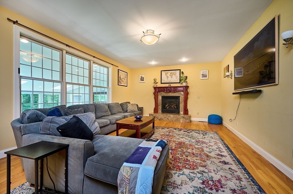 5 Deer Haven Drive Williamsburg, MA 01039 - Photo 19 of 42 a living room with furniture a flat screen tv and a fireplace