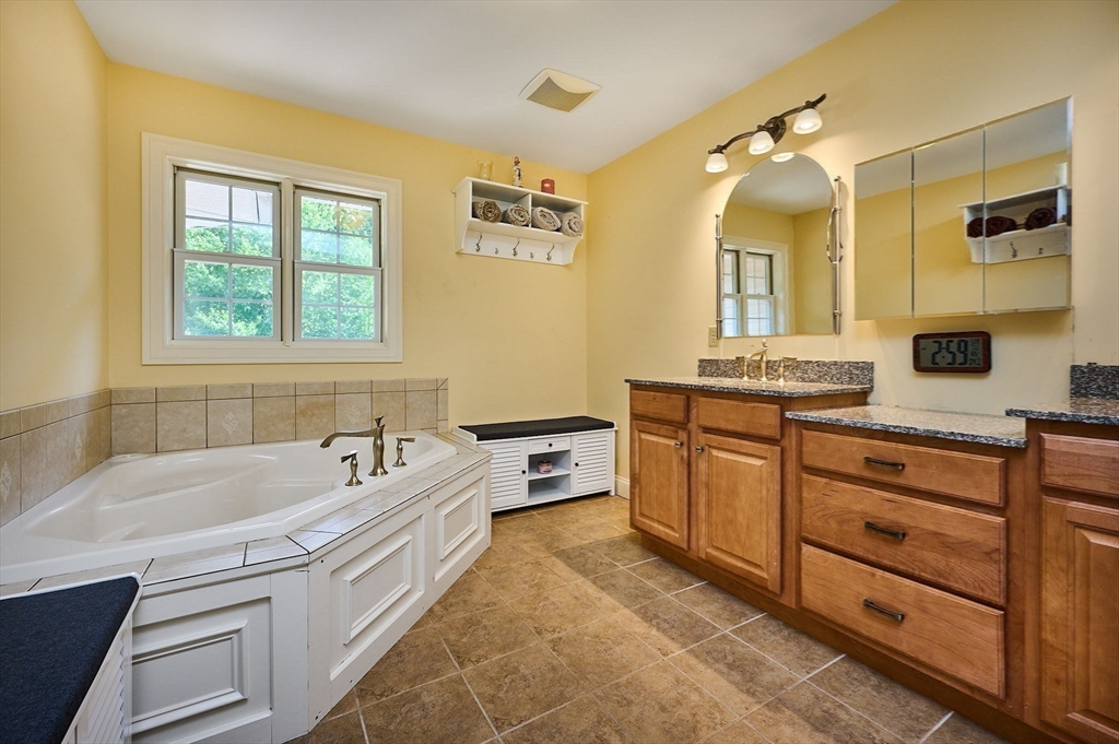 5 Deer Haven Drive Williamsburg, MA 01039 - Photo 35 of 42 a spacious bathroom with a granite countertop tub sink and mirror