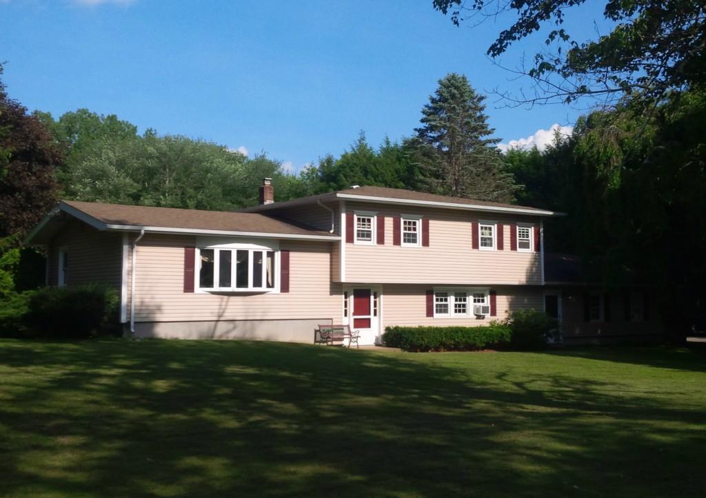 a front view of a house with a garden