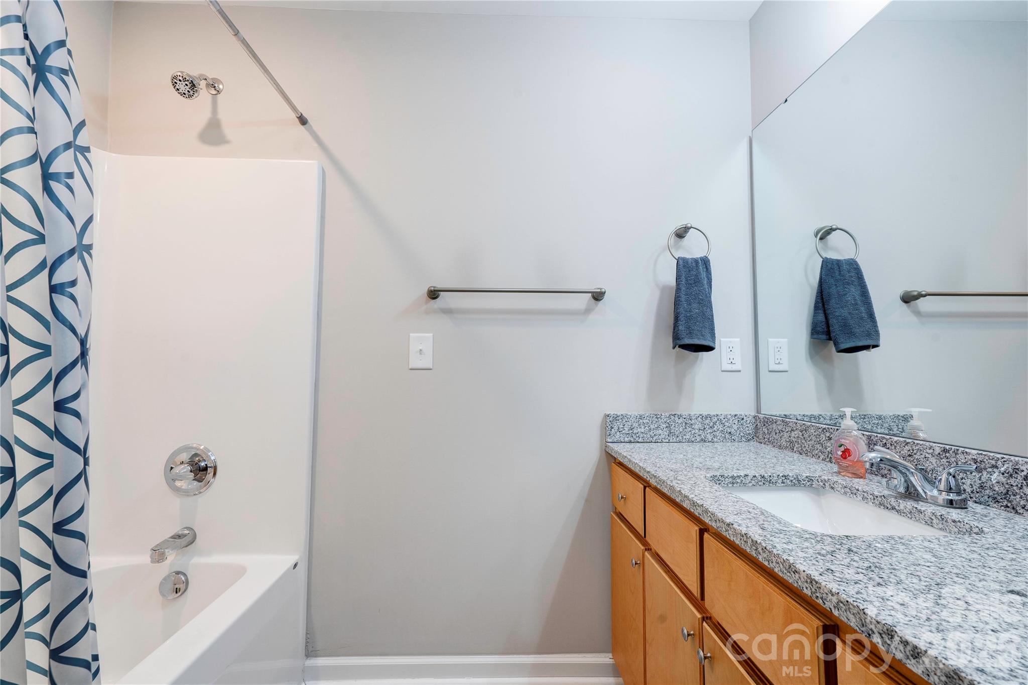 939 Costner Road Shelby, NC 28150 - Photo 16 of 34 a bathroom with a granite countertop sink and a bathtub