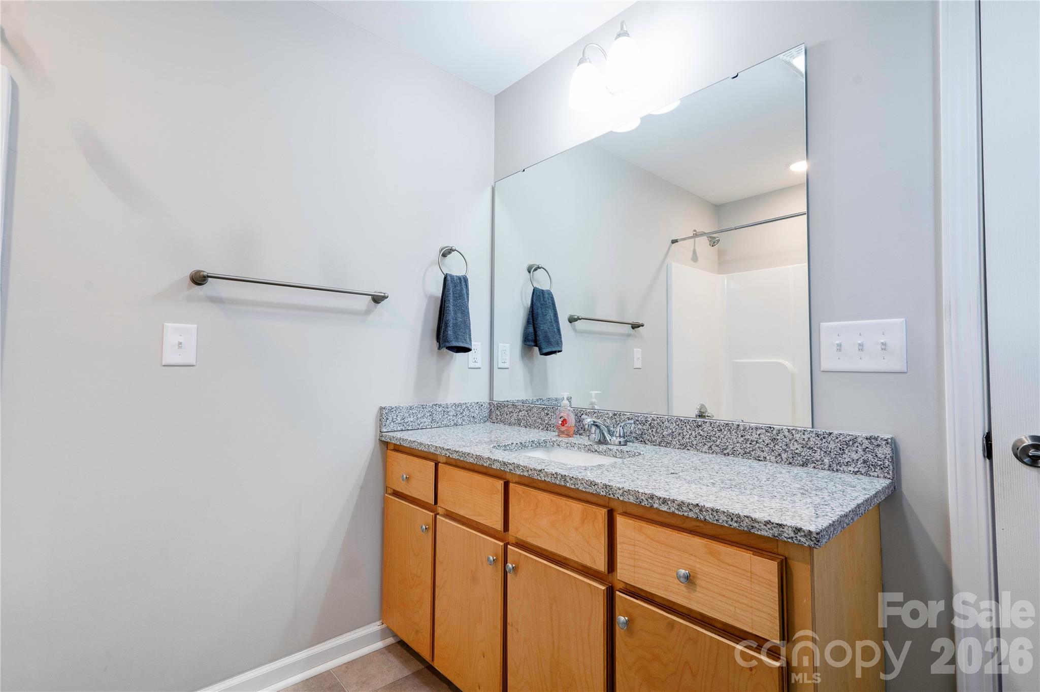 939 Costner Road Shelby, NC 28150 - Photo 17 of 34 a bathroom with a granite countertop sink and a mirror