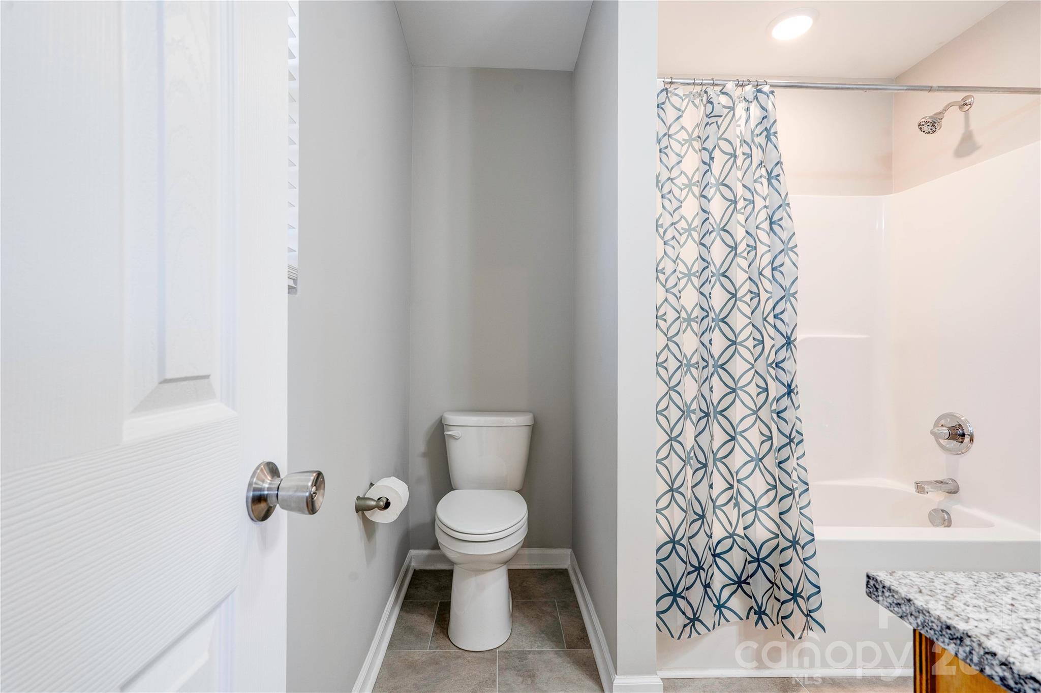 939 Costner Road Shelby, NC 28150 - Photo 18 of 34 a white toilet sitting next to a shower curtain
