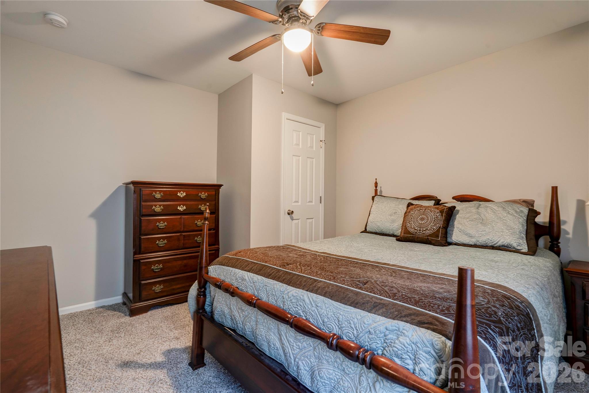 939 Costner Road Shelby, NC 28150 - Photo 20 of 34 a bedroom with a bed and a chandelier