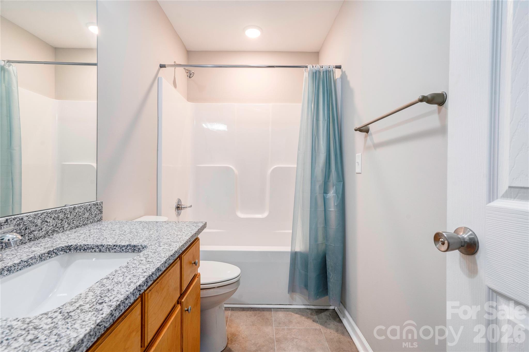 939 Costner Road Shelby, NC 28150 - Photo 21 of 34 a bathroom with a granite countertop sink toilet and shower