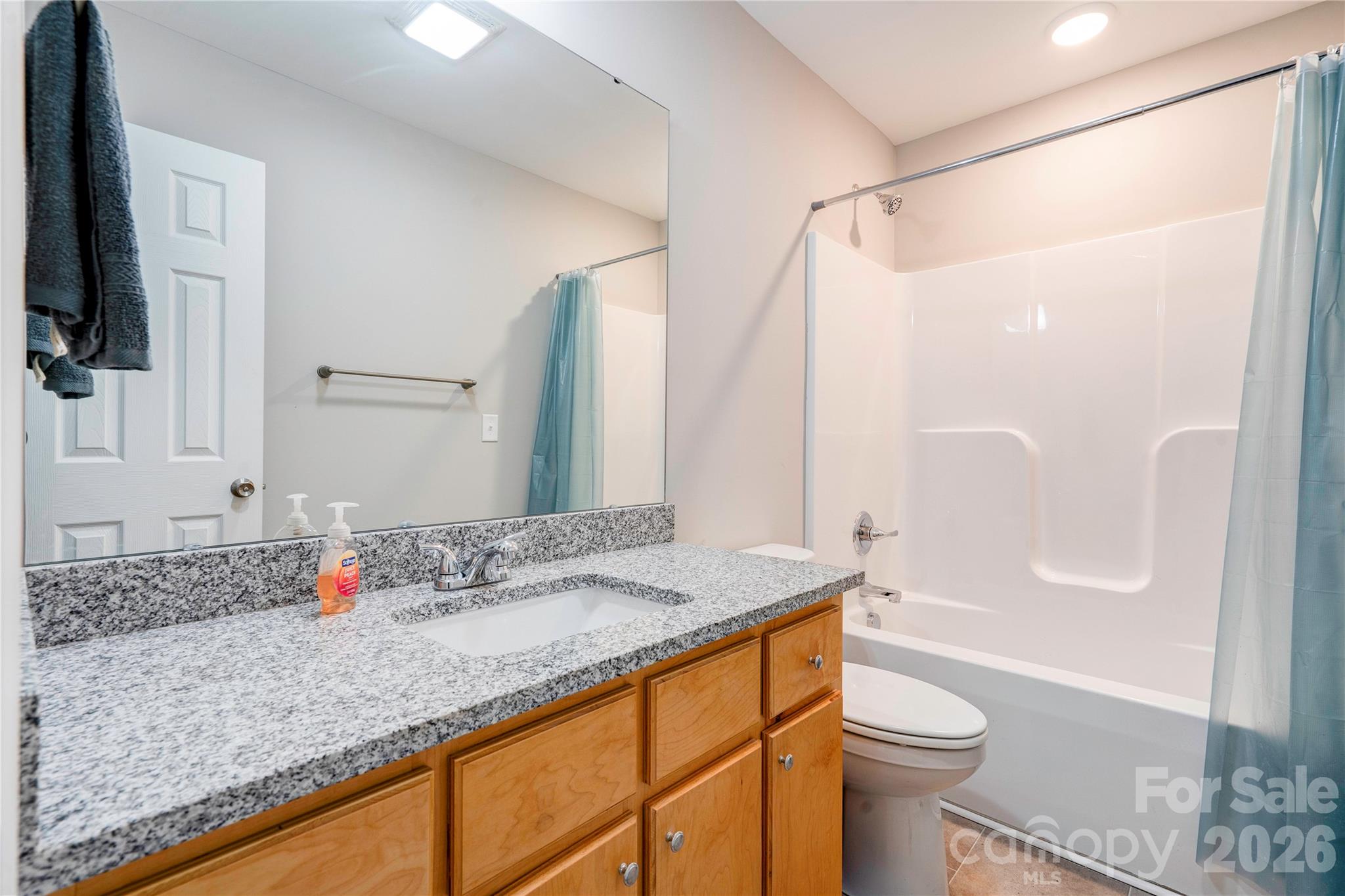 939 Costner Road Shelby, NC 28150 - Photo 22 of 34 a bathroom with a granite countertop sink a toilet and shower