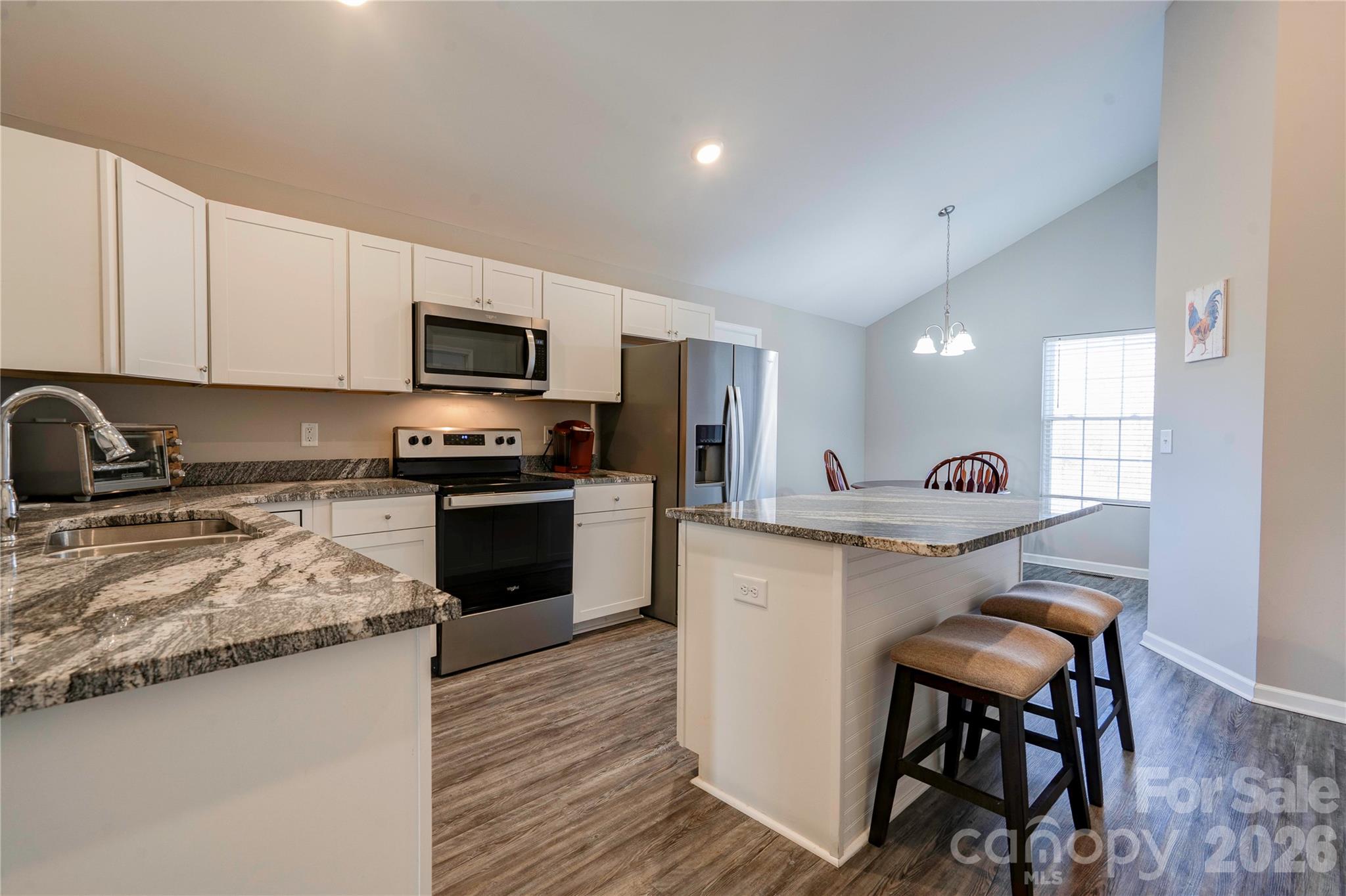 939 Costner Road Shelby, NC 28150 - Photo 5 of 34 a kitchen with granite countertop white cabinets and stainless steel appliances
