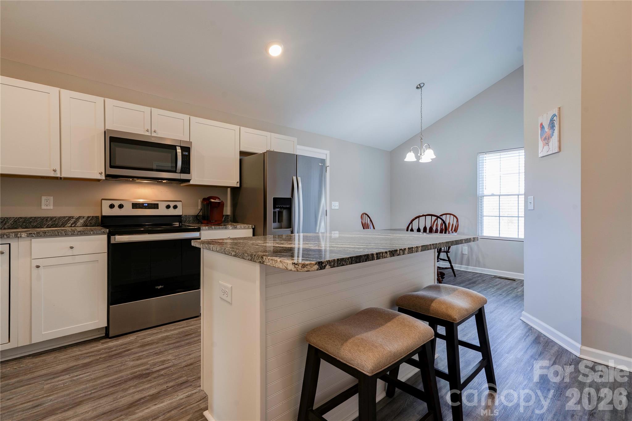 939 Costner Road Shelby, NC 28150 - Photo 6 of 34 a kitchen with stainless steel appliances kitchen island granite countertop a stove a sink and a microwave