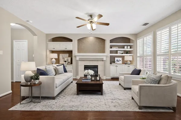 a view of an empty room with a fireplace and a window